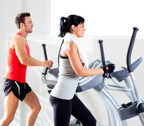 Man and woman on a cross-trainer